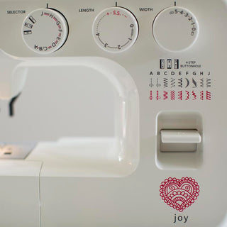A Baby Lock Joy Sewing Machine with a red heart on it.