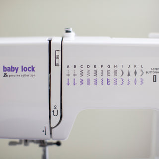 A white Baby Lock Zeal sewing machine with the word Baby Lock on it.