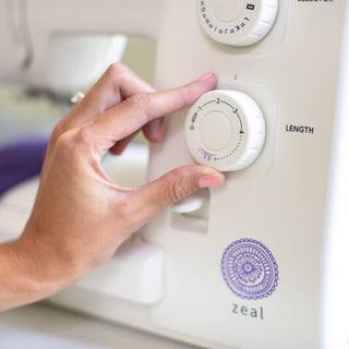A person using a Baby Lock Zeal Sewing Machine by Baby Lock.