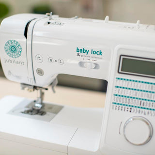 A Baby Lock Jubilant Sewing Machine sits on a table.