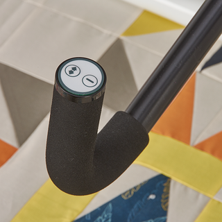 A close up of a black handle on a Baby Lock Gallant with Villa Frame quilt.