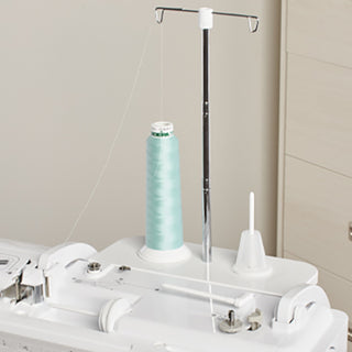 A Baby Lock Ballad Sewing and Quilting Machine with a spool of thread.
