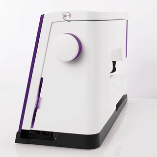 A white and purple PFAFF Expression 710 Sewing and Quilting Machine on a white surface.