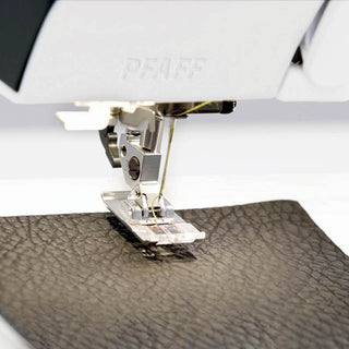 A Pfaff Quilt Expression 720 Sewing and Quilting Machine is being used to sew a piece of leather.