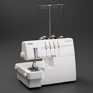 A white Pfaff Hobbylock 2.5 sewing machine on a black background.