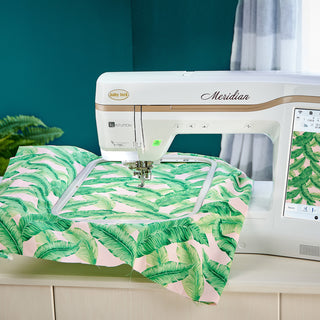 A Baby Lock Meridian Embroidery Only Machine with a green and pink fabric on it.