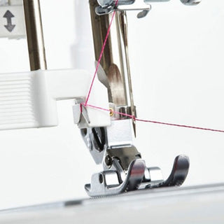 A Smarter by Pfaff 160s sewing machine with a pink thread attached to it.