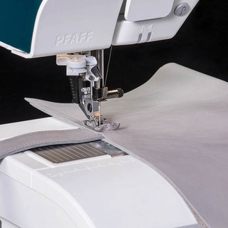 A Pfaff Performance Icon Sewing and Quilting Machine is being used to sew a piece of fabric.
