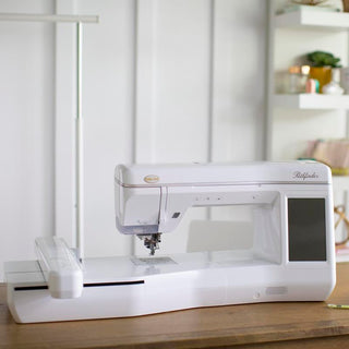 A Baby Lock Pathfinder Embroidery Machine with IQ Technology sits on top of a table.
