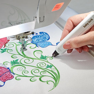 A person is using the Baby Lock Pathfinder Embroidery Machine with IQ Technology to make a design.