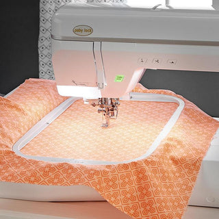 The Baby Lock Pathfinder Embroidery Machine, equipped with IQ Technology, is expertly paired with a piece of fabric for precise and efficient sewing.