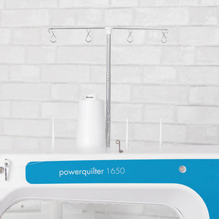 A Pfaff Powerquilter 1650 Stand Up Quilter with a 5' Frame with a blue and white design.