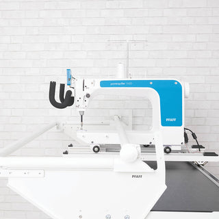 A PFAFF Powerquilter 1650 Stand Up Quilter with 5' Frame on top of a white wall.