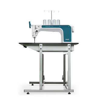 A Pfaff Powerquilter 1600 Stationary Quilter with Table on top of a table.