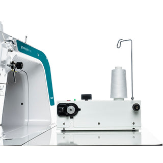 A PFAFF Powerquilter 1600 Stationary Quilter with Table sewing machine with a bobbin on it.