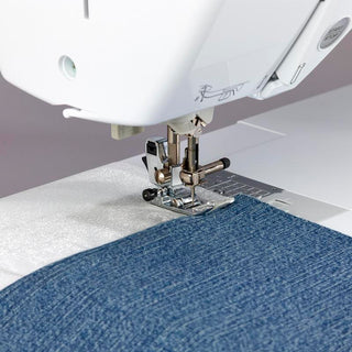 A Baby Lock Soprano Sewing and Quilting Machine is being used to sew a piece of fabric.