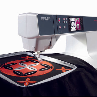 A Pfaff Creative 3.0 Sewing and Embroidery Machine with a red and black design on it.