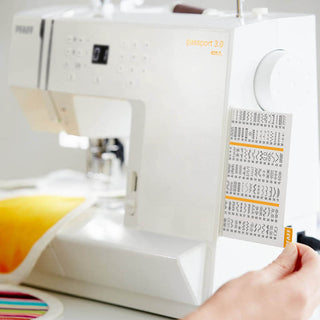 A person is sewing on a Pfaff Passport 3.0 sewing machine.