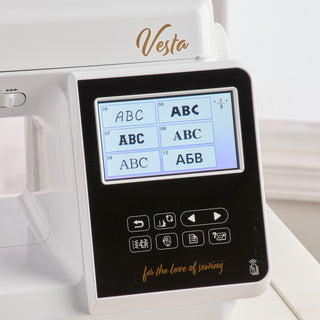 A white Baby Lock Vesta Sewing & Embroidery Machine with an abc display.