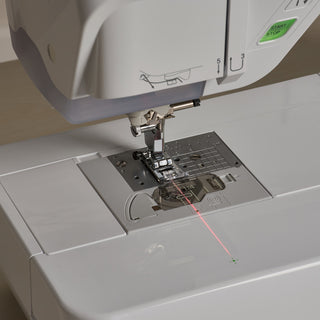 A Baby Lock Vesta Sewing & Embroidery Machine with a laser attached to it.