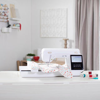 A Baby Lock Vesta Sewing & Embroidery Machine sits on a table in a room.