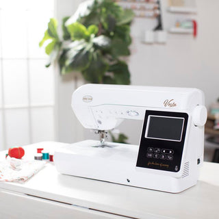 A Baby Lock Vesta Sewing & Embroidery Machine sits on top of a table.