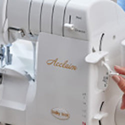 A person using a Baby Lock Acclaim Serger sewing machine.