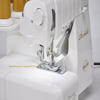A Baby Lock Accolade Serger with a yellow thread on it.
