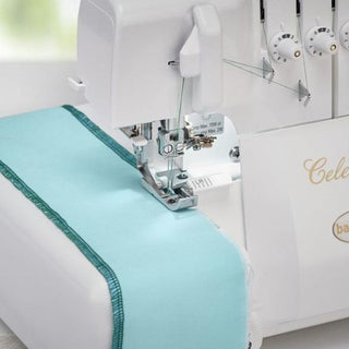 A Baby Lock Celebrate Serger sewing machine with a turquoise fabric.