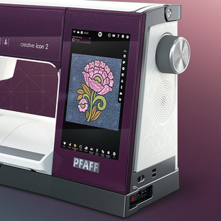 A PFAFF Creative Icon 2 - Purple Aurora sewing machine with a flower on it.