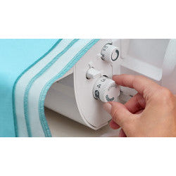 A person using a Baby Lock Acclaim Serger with a blue cover.
