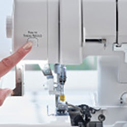 A person is using a Baby Lock Acclaim Serger to sew.