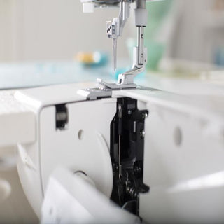 A close up of a Baby Lock Euphoria Coverstitch Serger sewing machine.