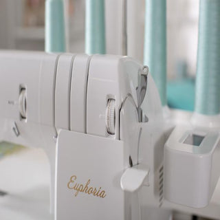 A Baby Lock Euphoria Coverstitch Serger with a needle and bobbin on it.